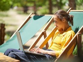 Woman with laptop outdoors.jpeg