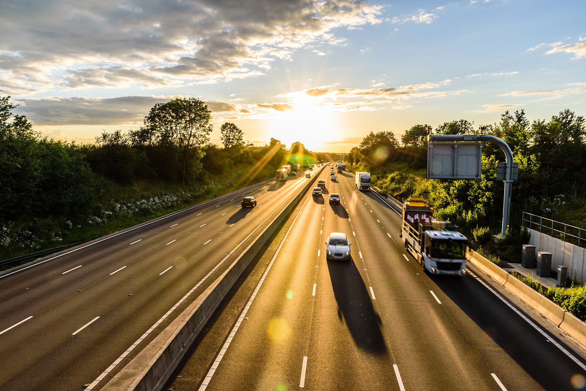 UK motorway with vehicles at sunset