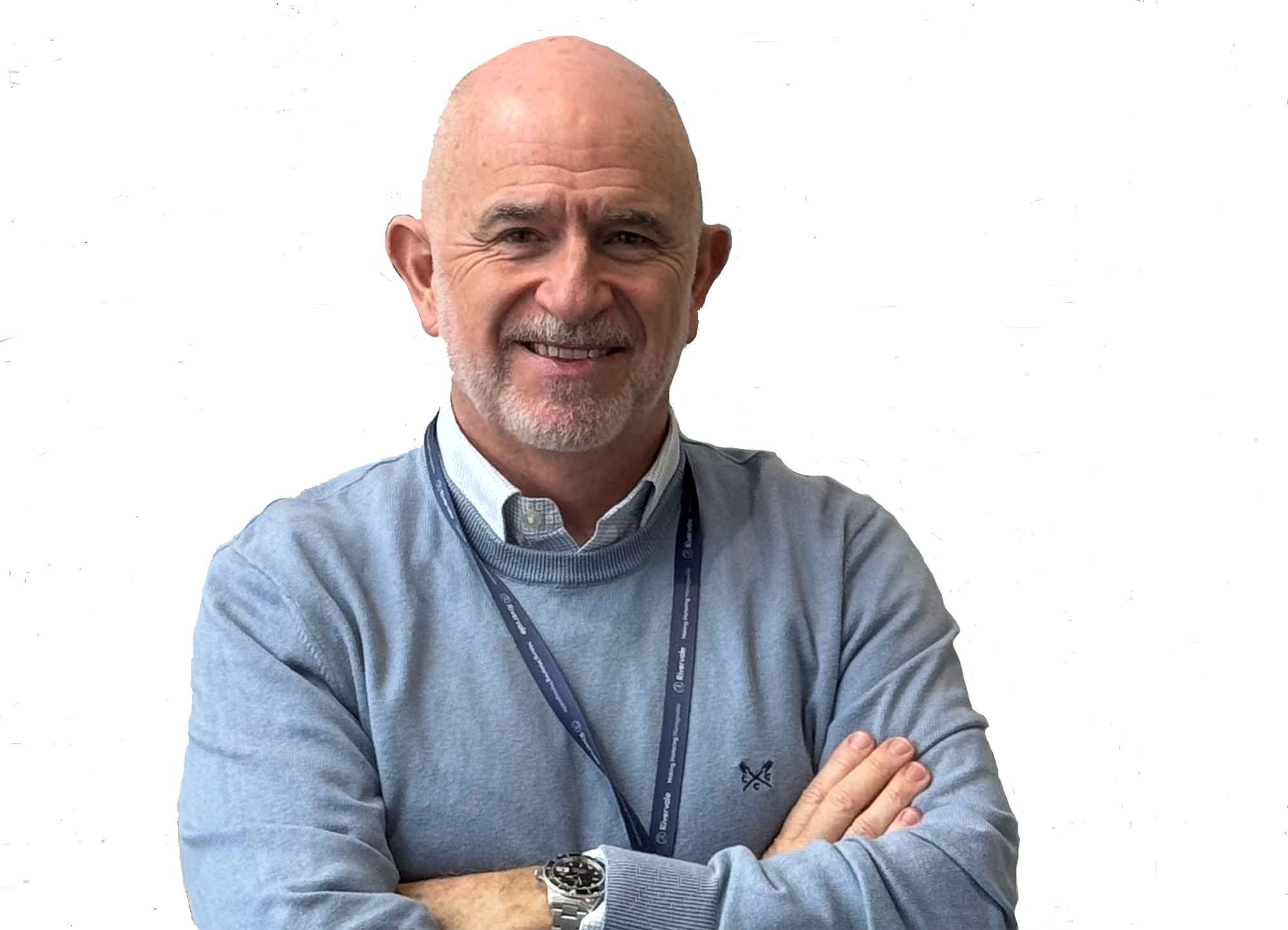 Vince Pemberton stands smiling with arms folded