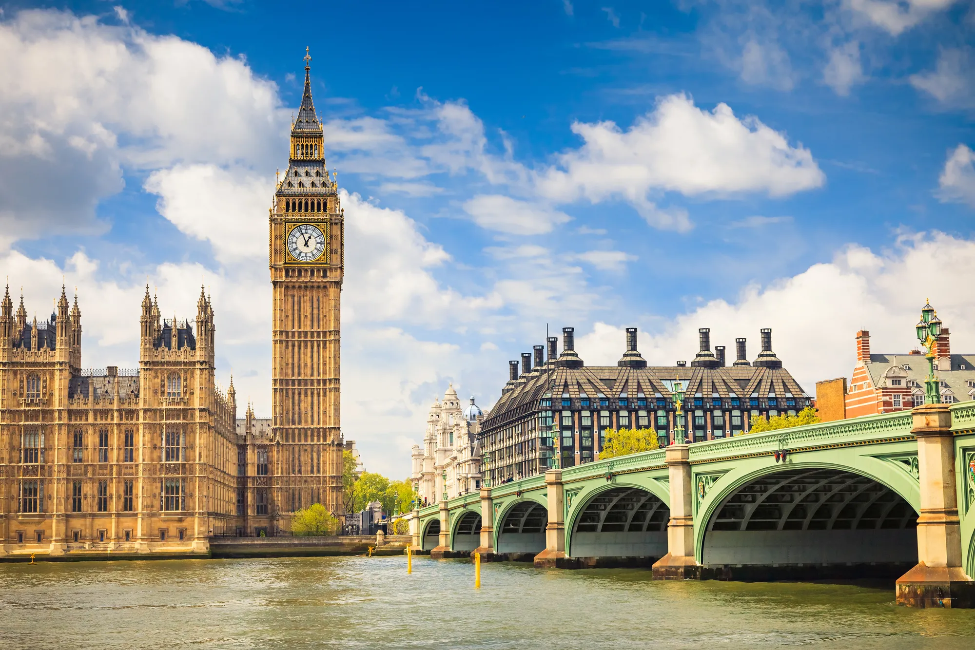 Colour photo of Big Ben and the House of Commons from the far side of Westminster bridge. 