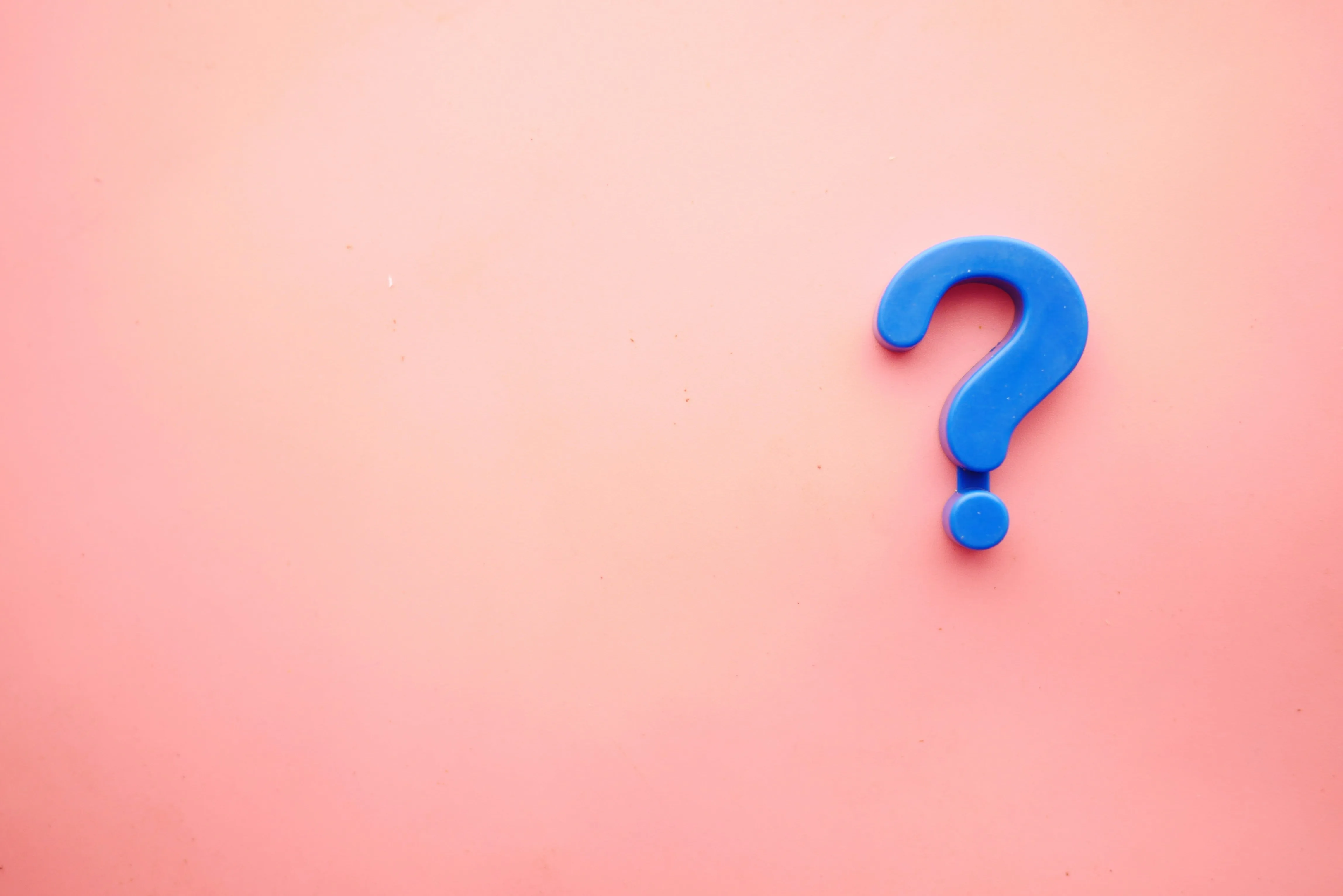 A blue question mark with a pink background