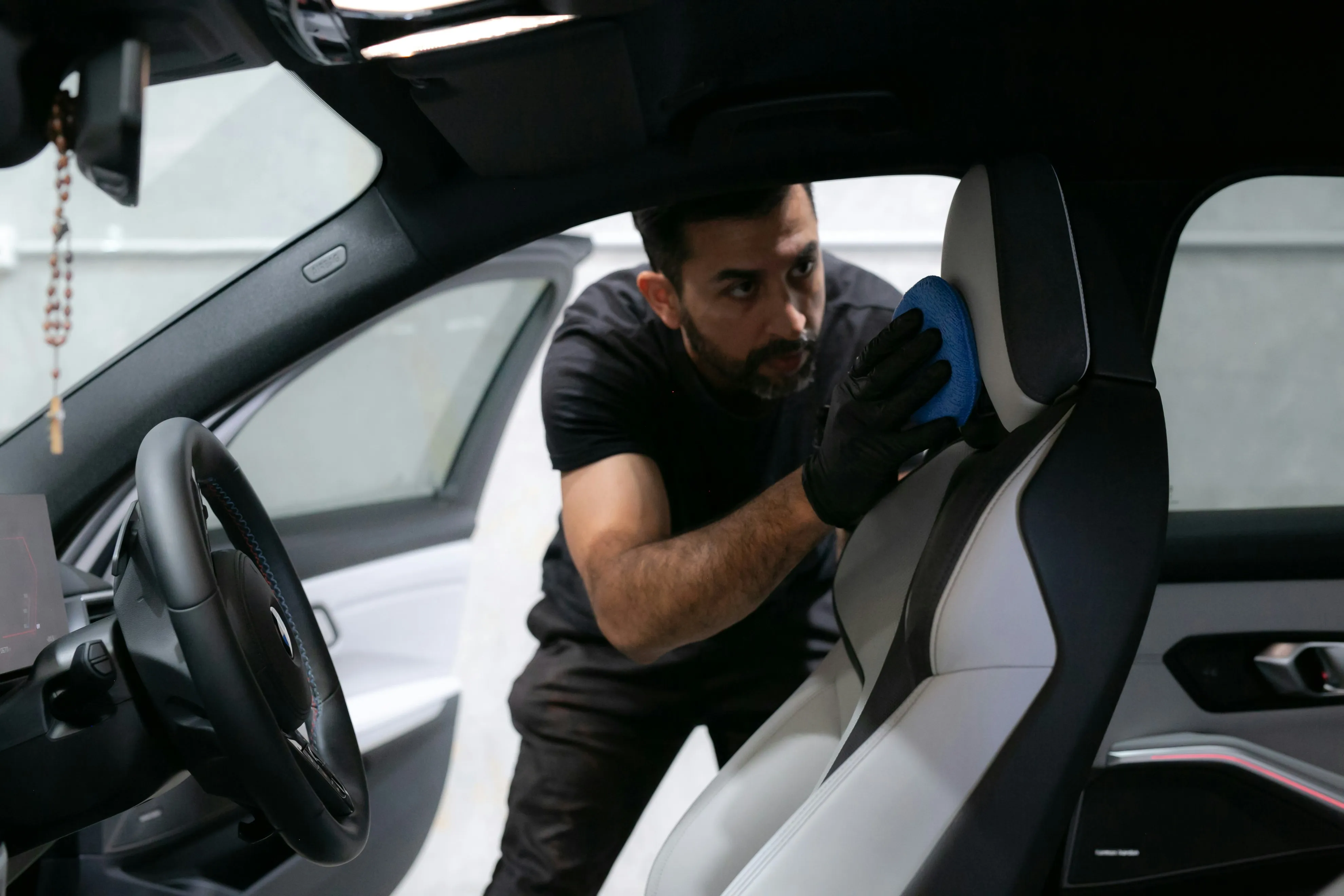 man inspecting car