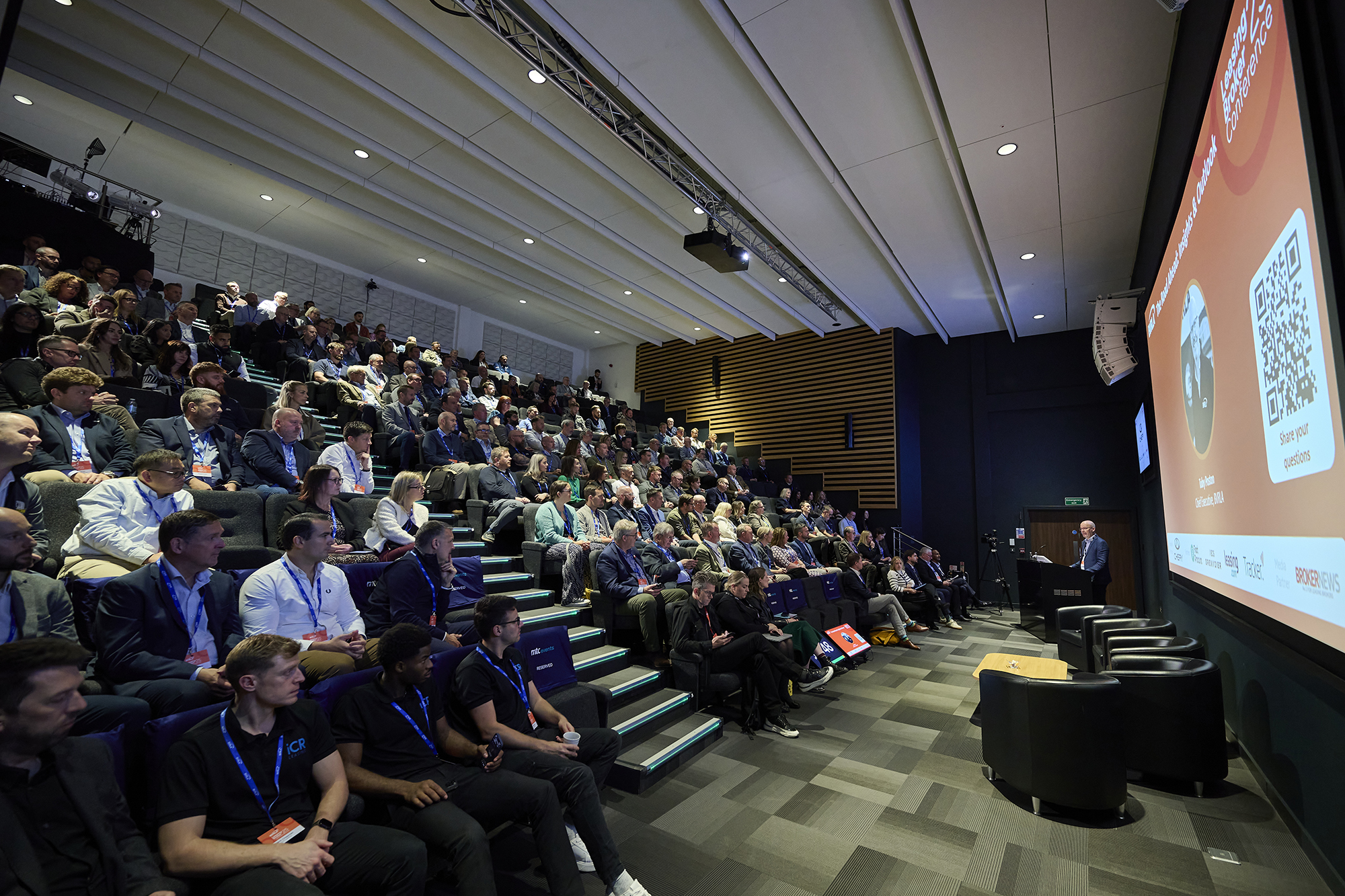 The auditorium at the 2025 BVRLA Leasing Broker Conference with Chief Executive Toby Poston addressing the room