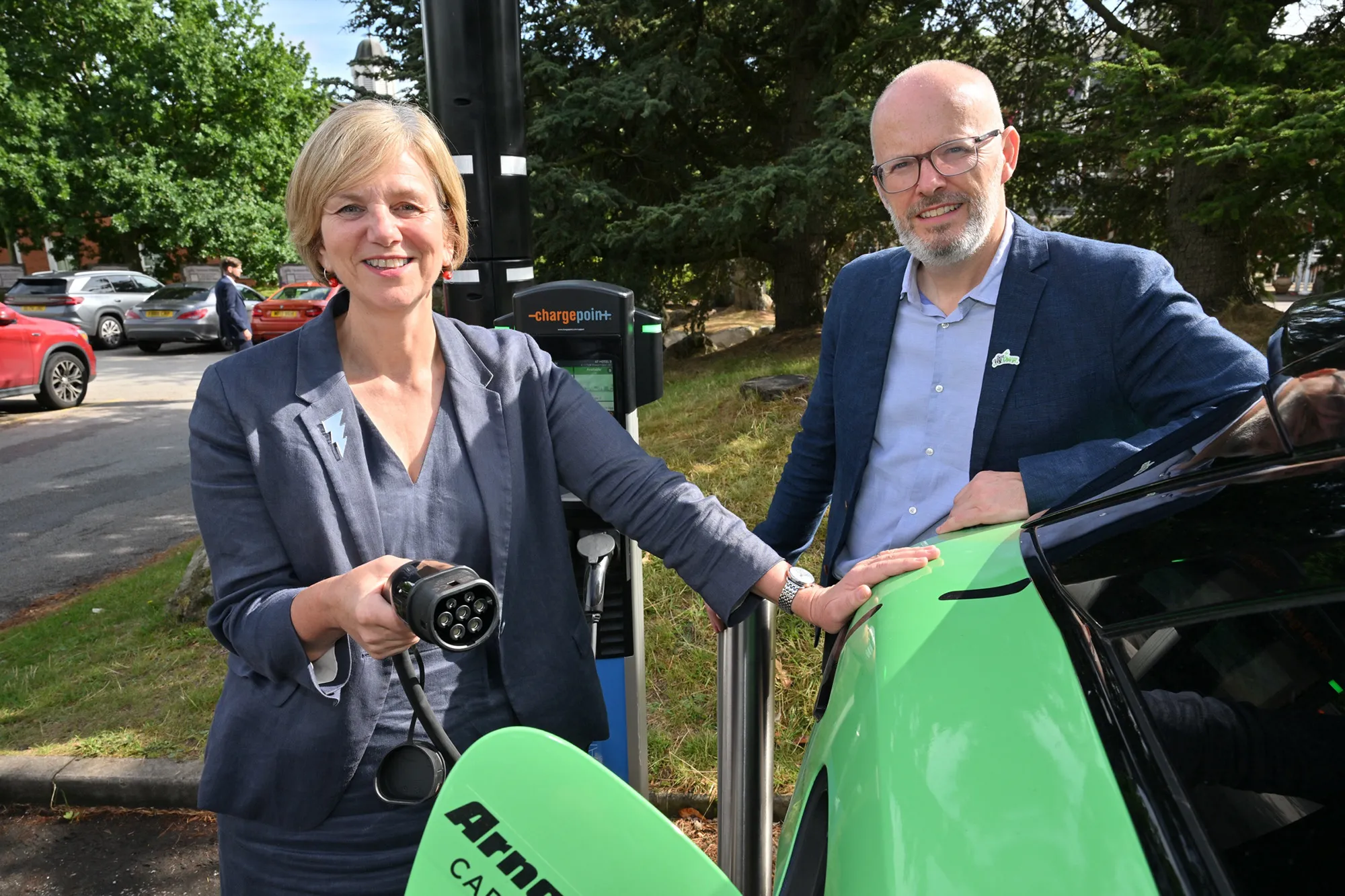 Transport Minister Lilian Greenwood, on the left, with BVRLA Chief Executive Toby Poston at Alton Towers Hotel with the Bon VoyCharge EV campaign car