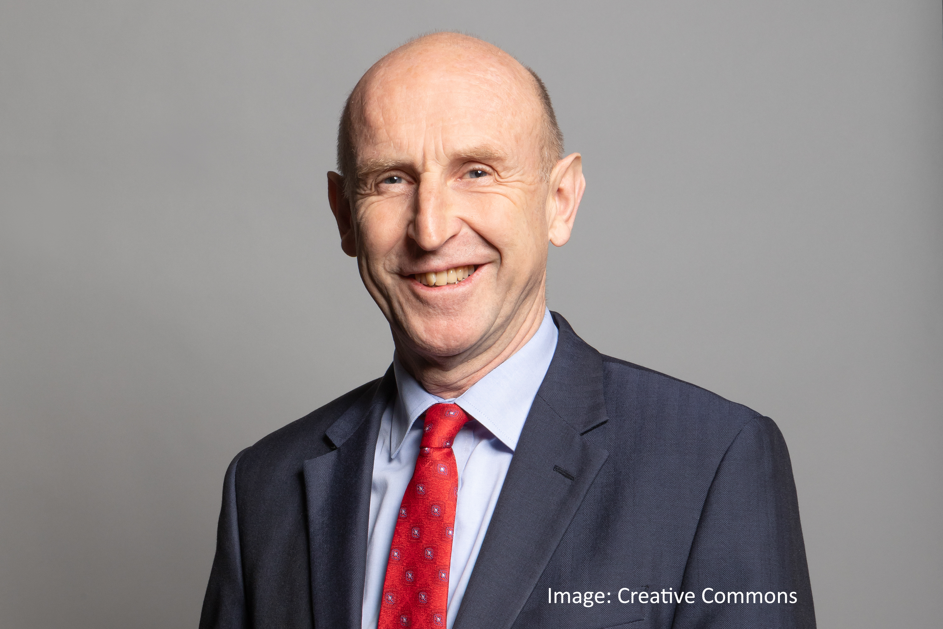 John Healey, UK Chancellor of the Exchequer, wearing red tie. Image: Creative Commons