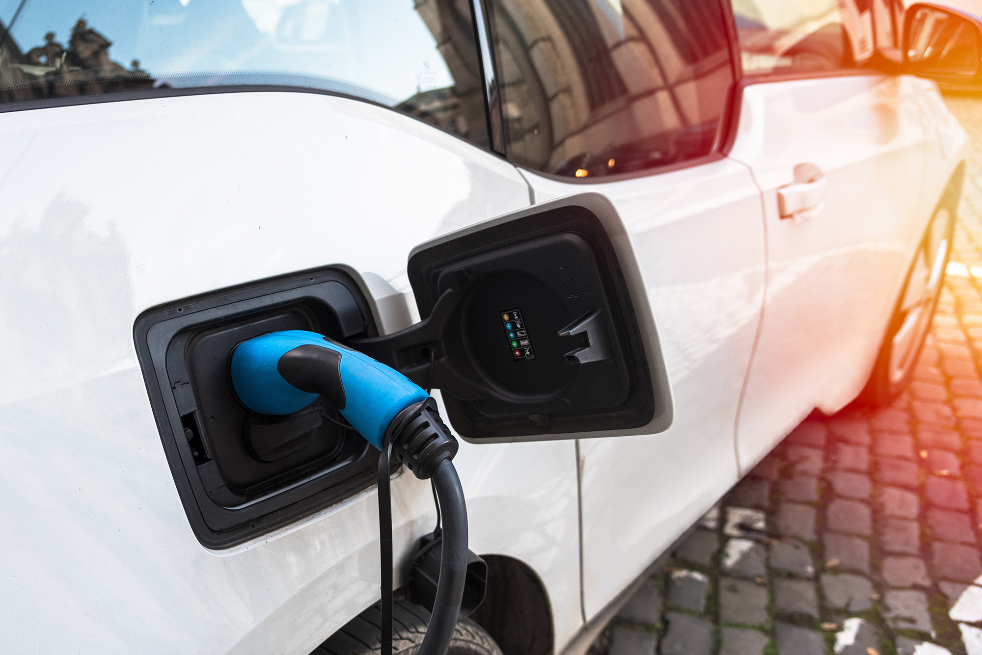 White EV charging on the street