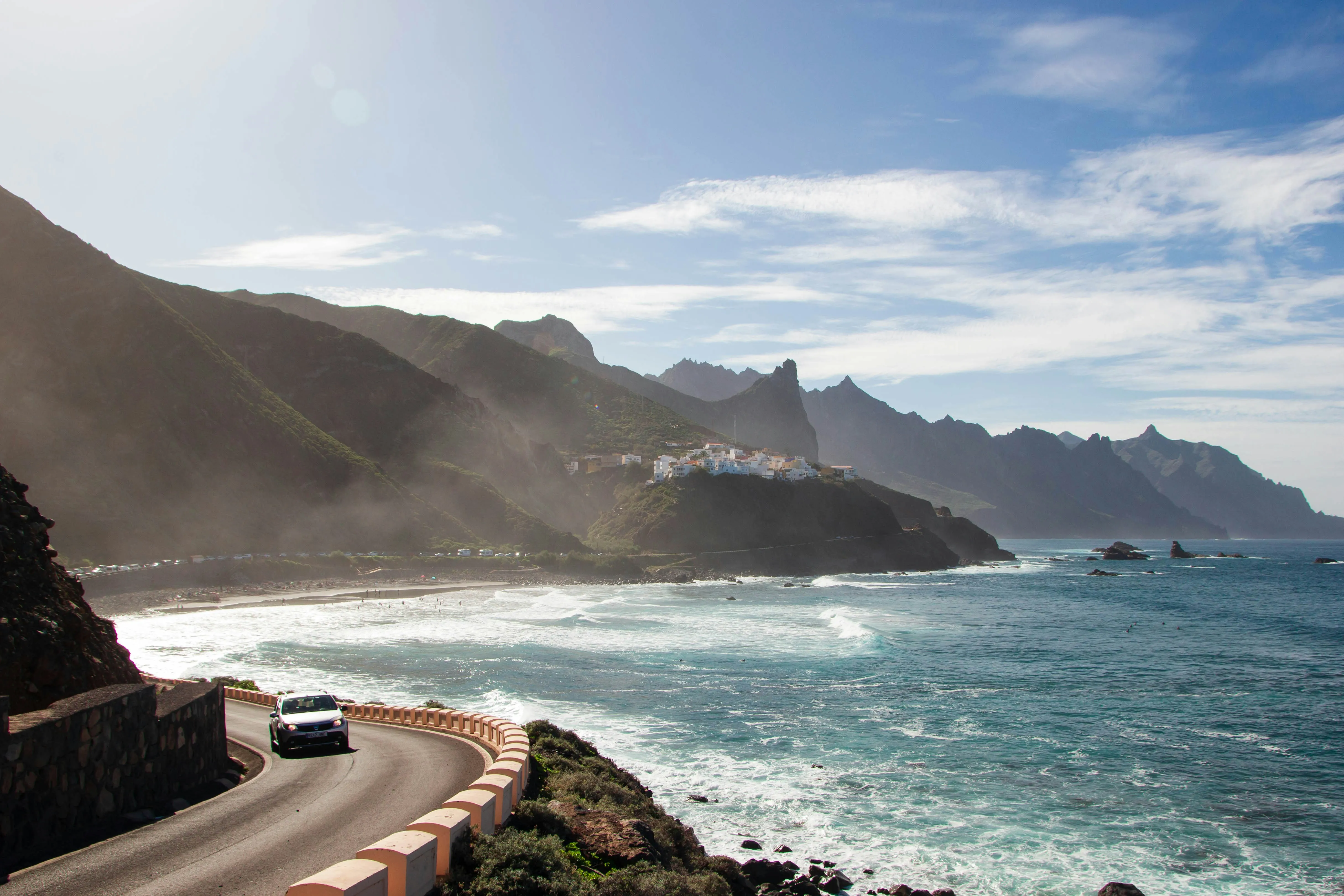 A car driving on a scenic coastal road